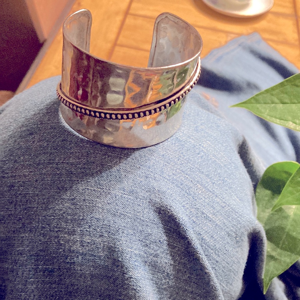 Cuff bracelet, silver in color, about 2 1/2” to:ins